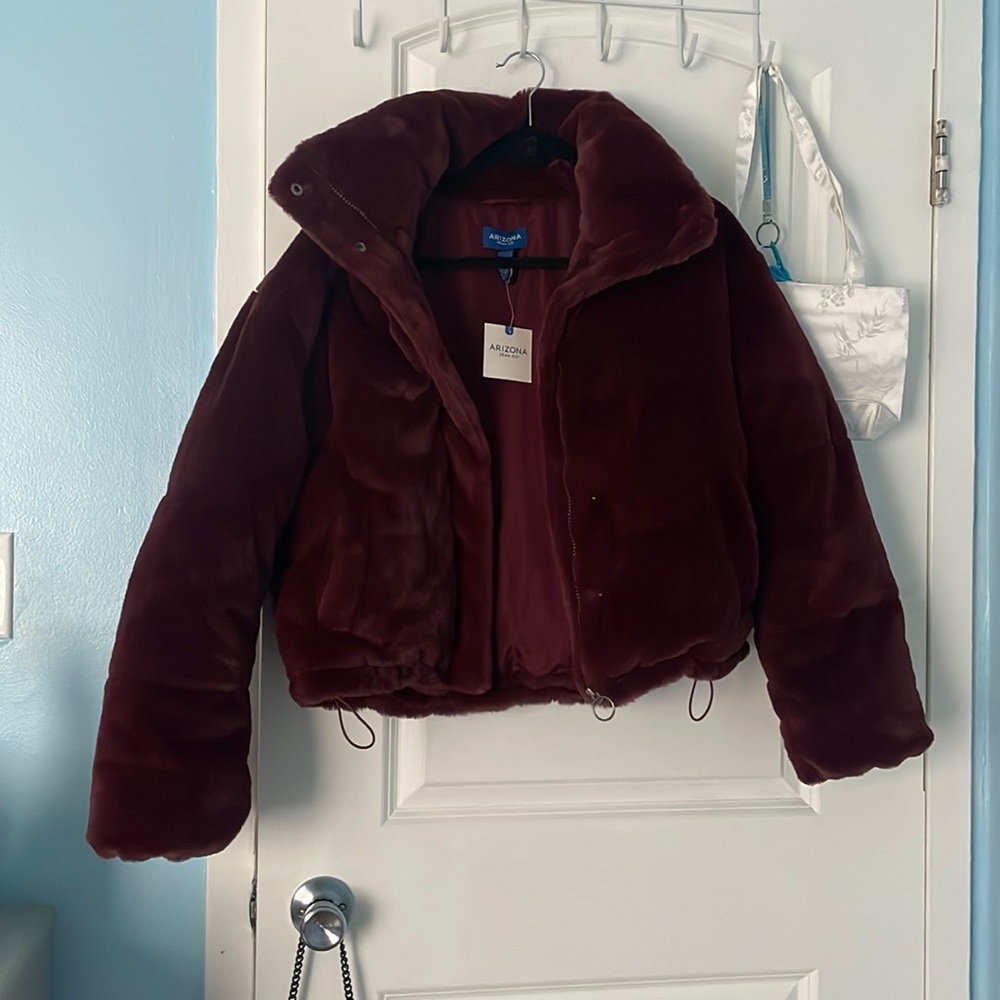 This is a soft maroon coat It has the original ticket and it has not been worn.